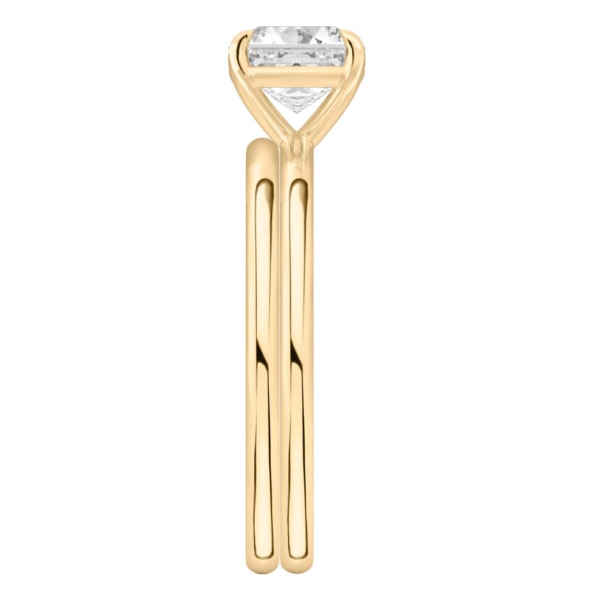 Side view of asscher cut diamond delicate solitaire engagement ring set yellow gold