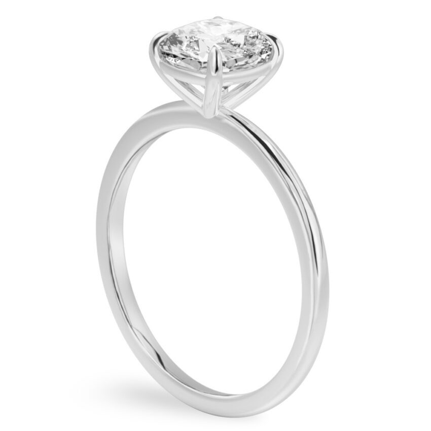 Angle view of cushion cut diamond delicate solitaire engagement ring palladium