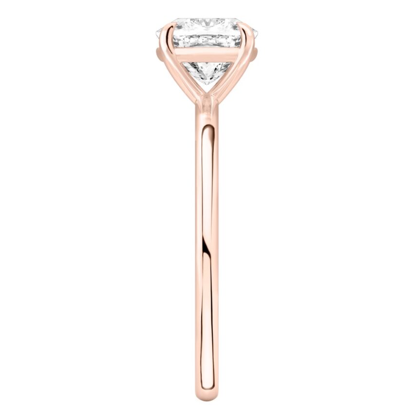 Side view of cushion cut diamond delicate solitaire engagement ring rose gold