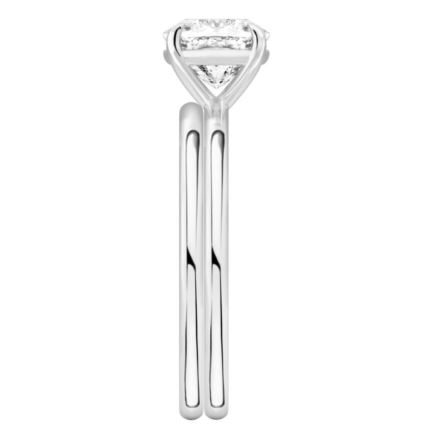 Side view of cushion cut diamond delicate solitaire engagement ring set palladium