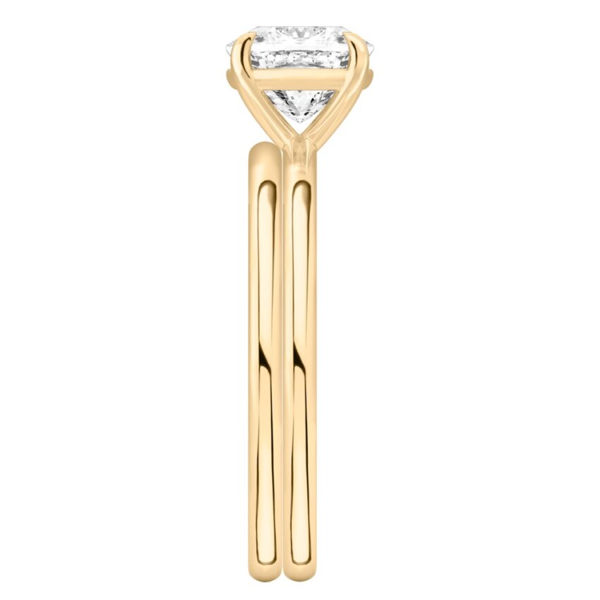 Side view of cushion cut diamond delicate solitaire engagement ring set yellow gold