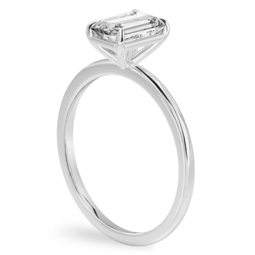 Angle view of emerald cut diamond delicate solitaire engagement ring palladium