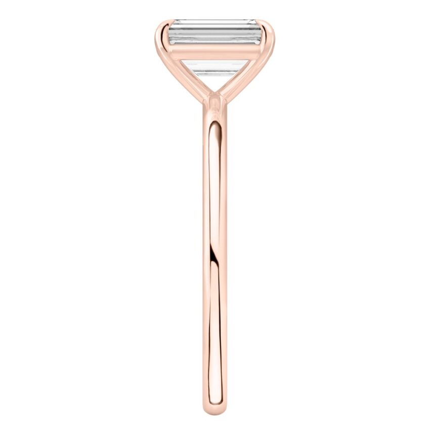 Side view of emerald cut diamond delicate solitaire engagement ring rose gold
