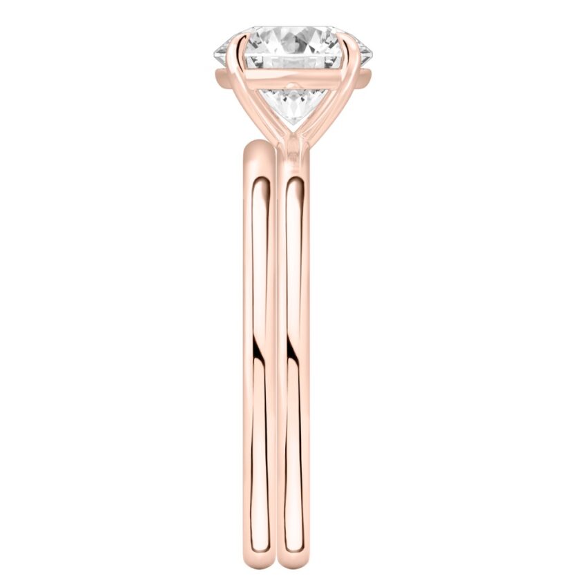 Side view of four prong round cut diamond delicate solitaire engagement ring set rose gold