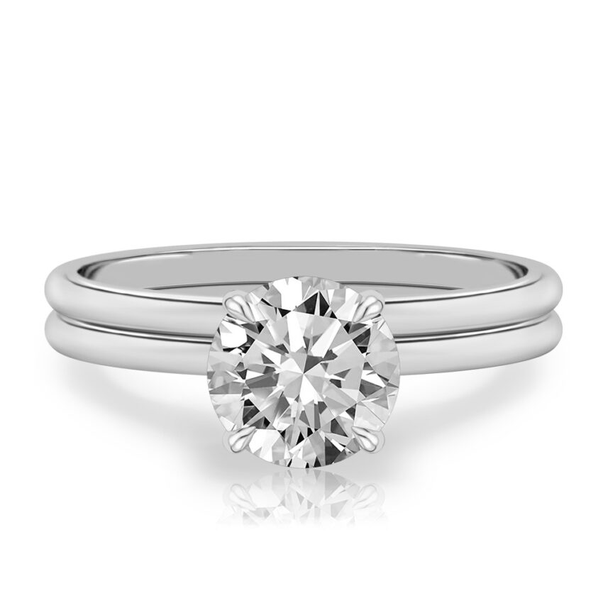 four prong round cut diamond delicate solitaire engagement ring in set white gold