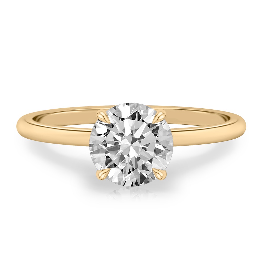 four prong round cut diamond delicate solitaire engagement ring in yellow gold