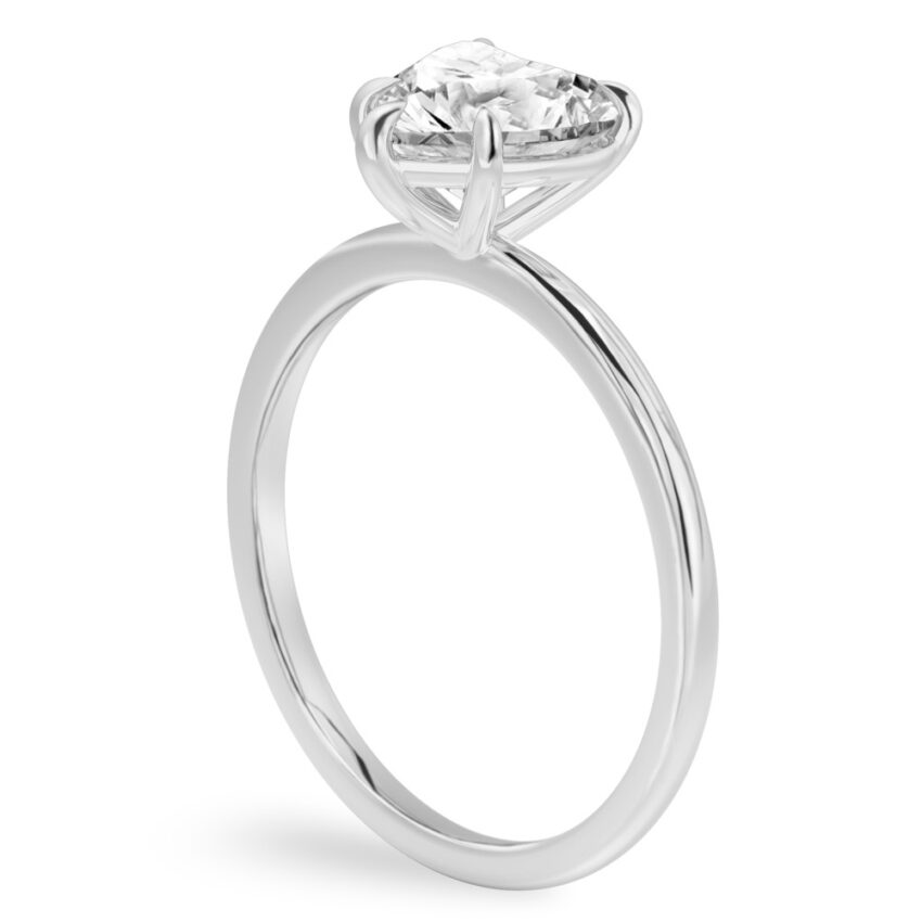 Angle view of heart shape diamond delicate solitaire engagement ring palladium