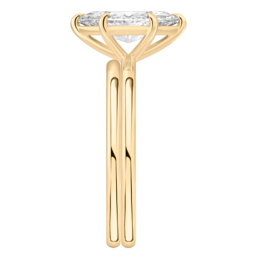 Side view of marquise cut diamond delicate solitaire engagement ring set yellow gold