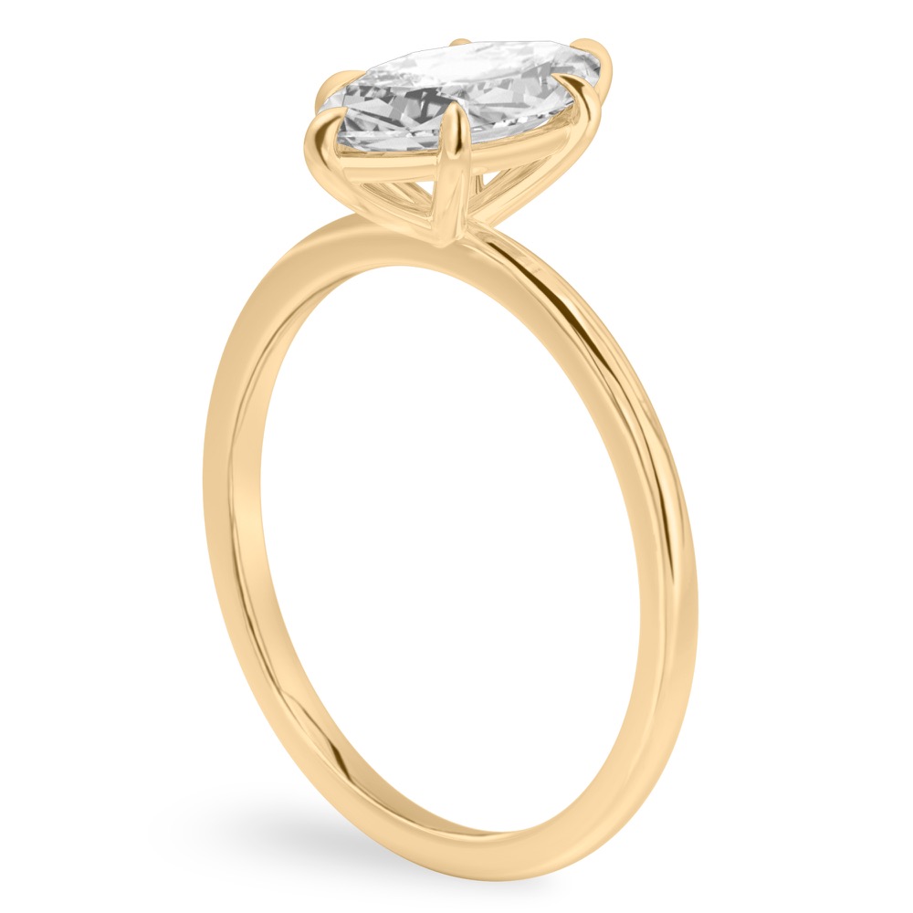 Angle view of marquise cut diamond delicate solitaire engagement ring yellow gold