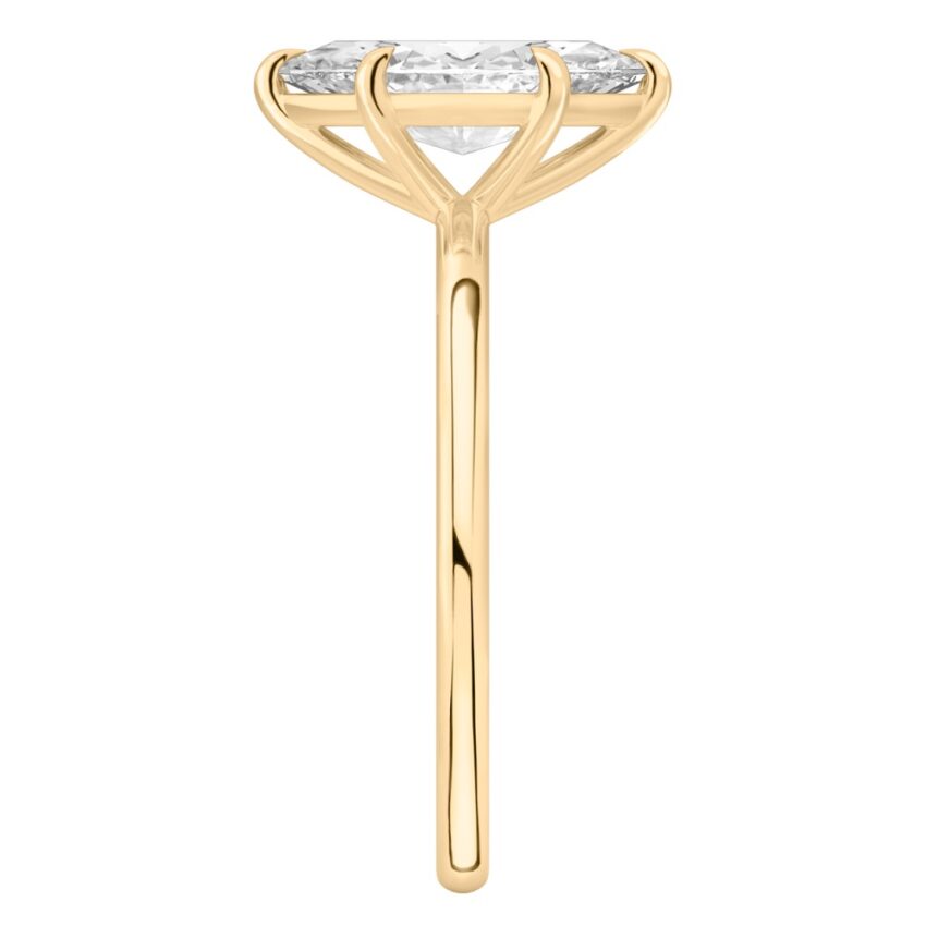 Side view of marquise cut diamond delicate solitaire engagement ring yellow gold
