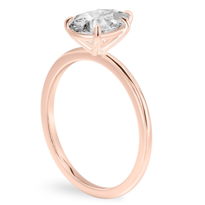 Angle view of pear shape diamond delicate solitaire engagement ring rose gold