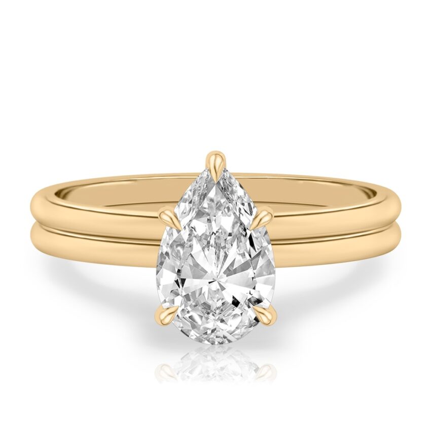 pear shape diamond delicate solitaire engagement ring in set yellow gold