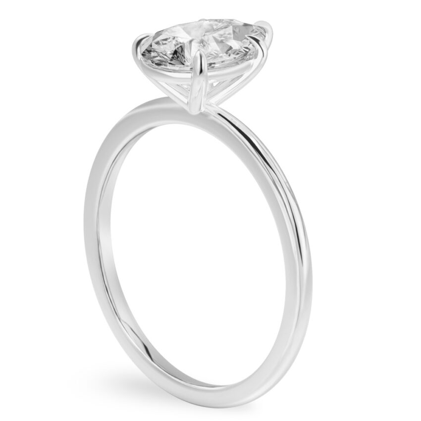 Angle view of pear shape diamond delicate solitaire engagement ring white gold