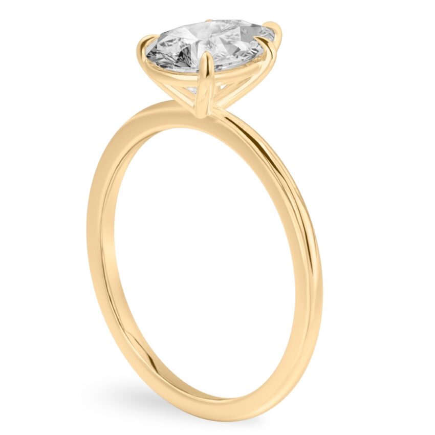Angle view of pear shape diamond delicate solitaire engagement ring yellow gold