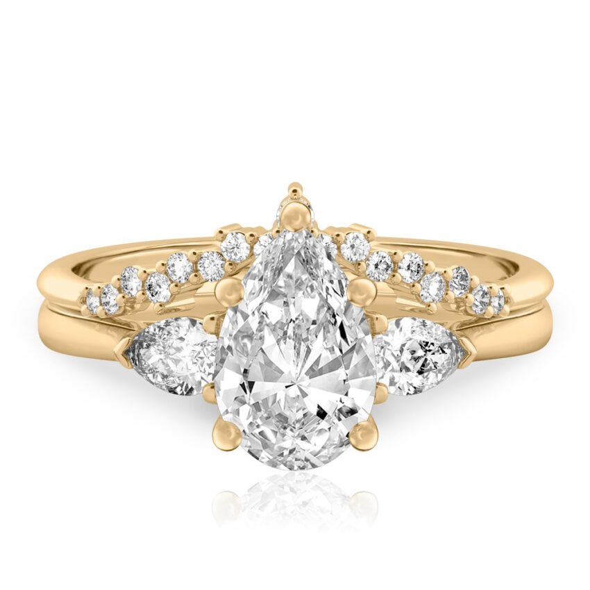 pear shape diamond pear side stone engagement ring set yellow gold