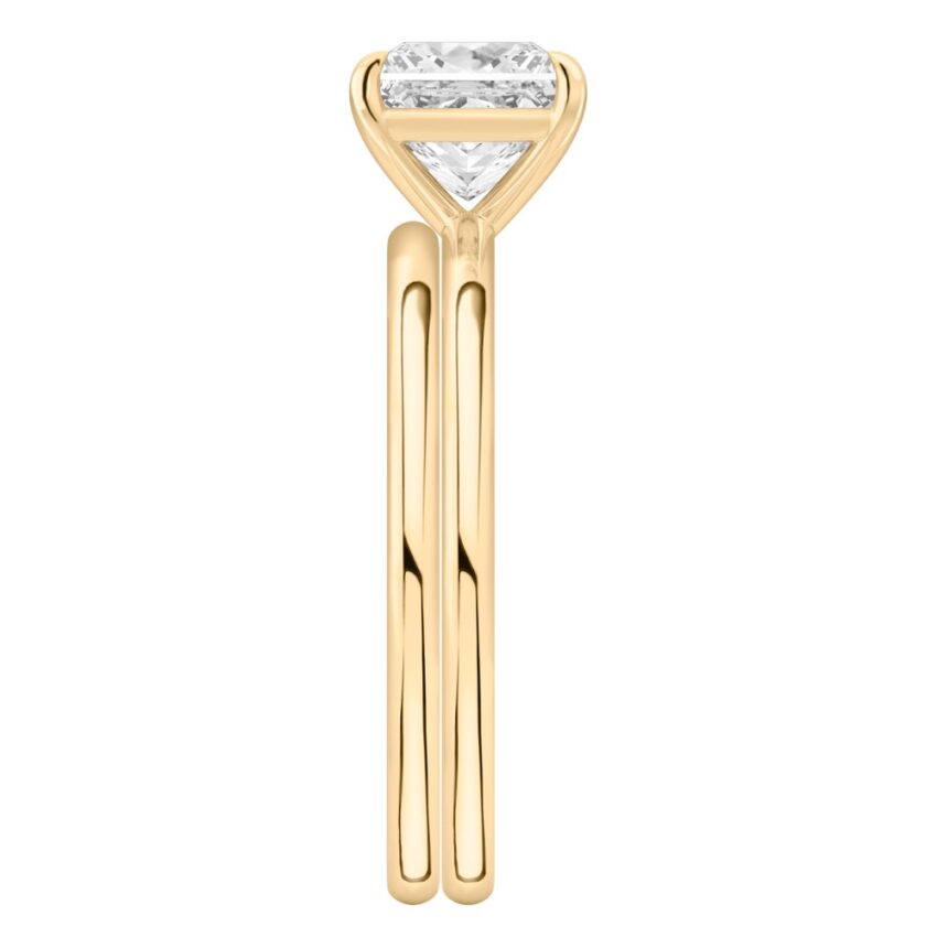 Side view of princess cut diamond delicate solitaire engagement ring set yellow gold
