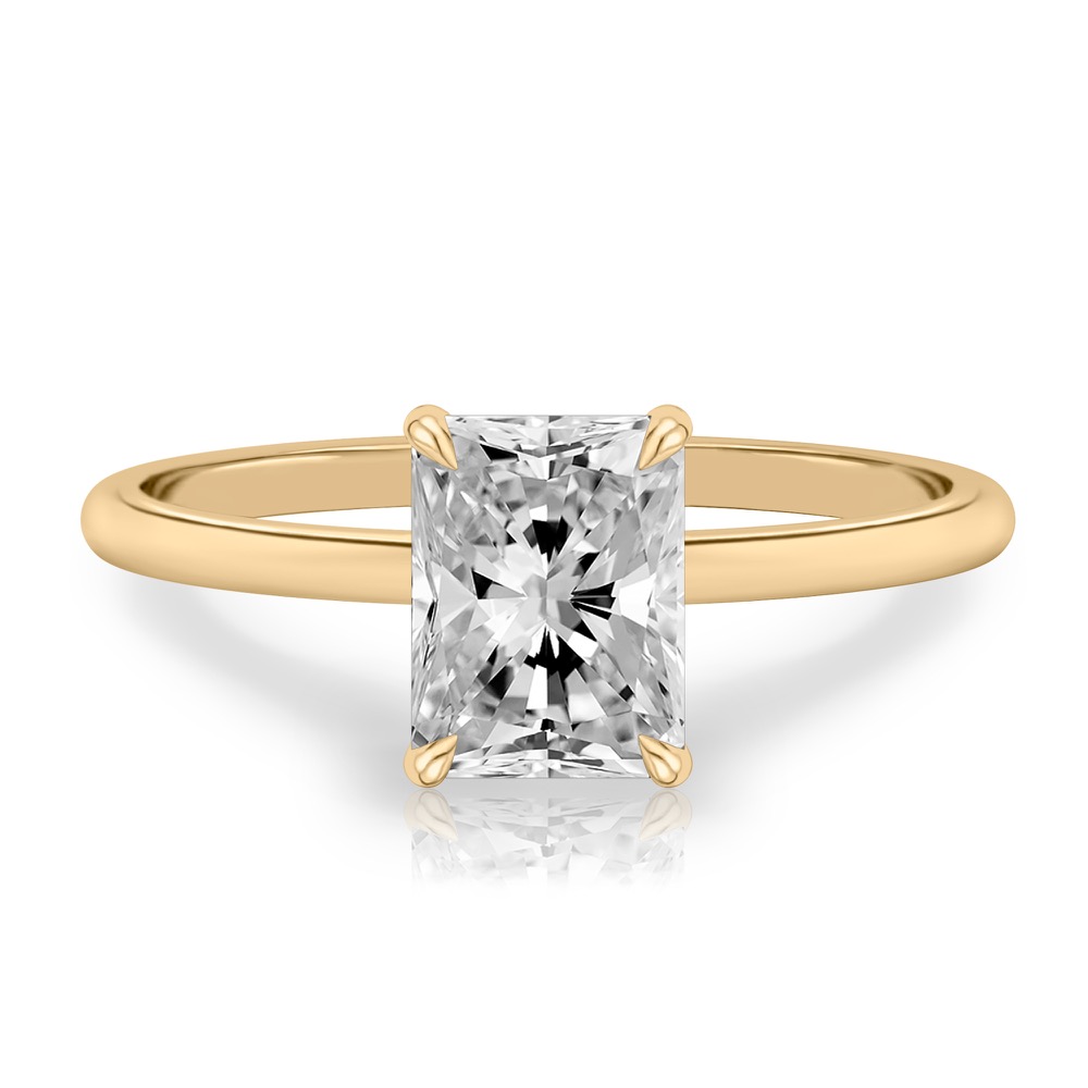 radiant cut diamond delicate solitaire engagement ring in yellow gold