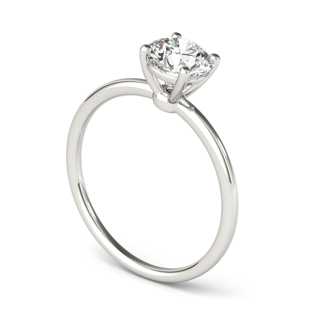 angle view of round cut diamond dainty solitaire engagement ring in platinum