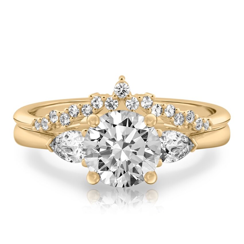 round cut diamond pear side stone engagement ring set yellow gold