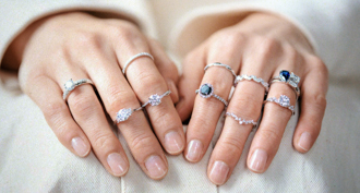 assortment of rings on hands from do amore xx atticus collection