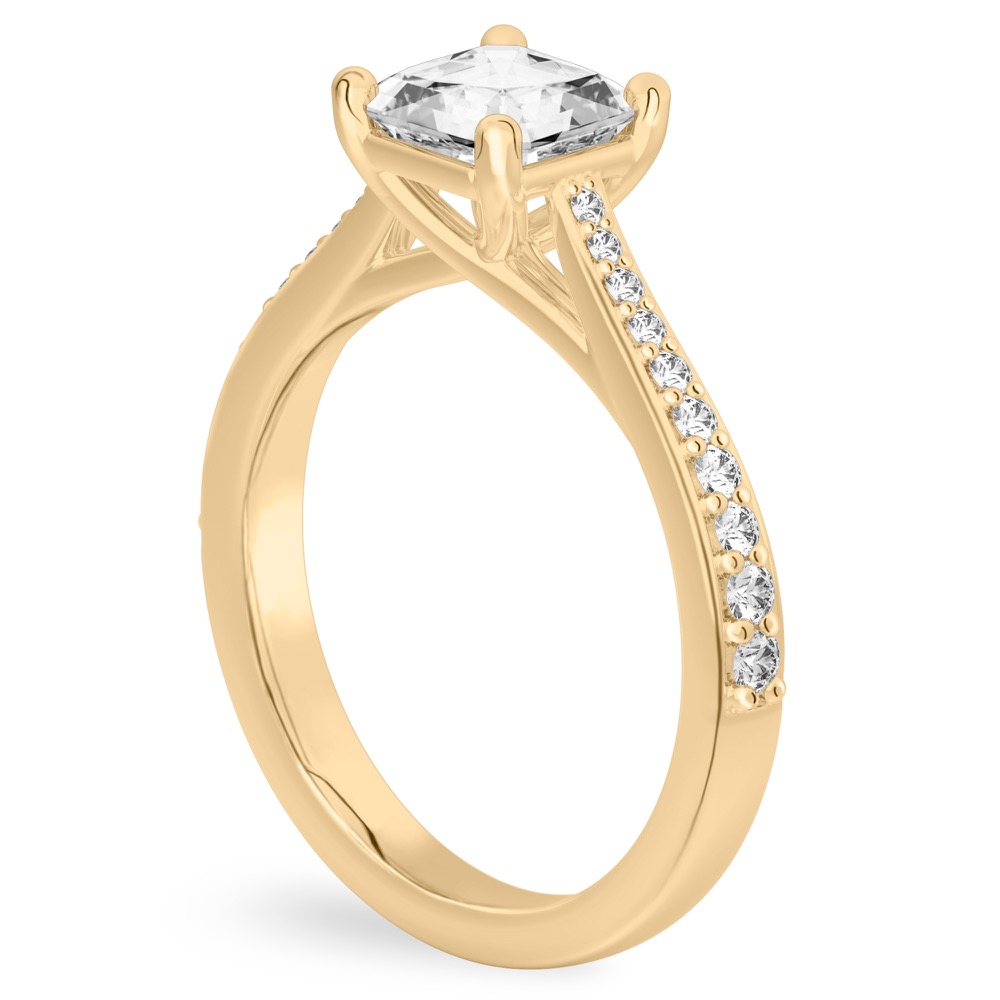 Angle view of asscher cut diamond tapered engagement ring in yellow gold