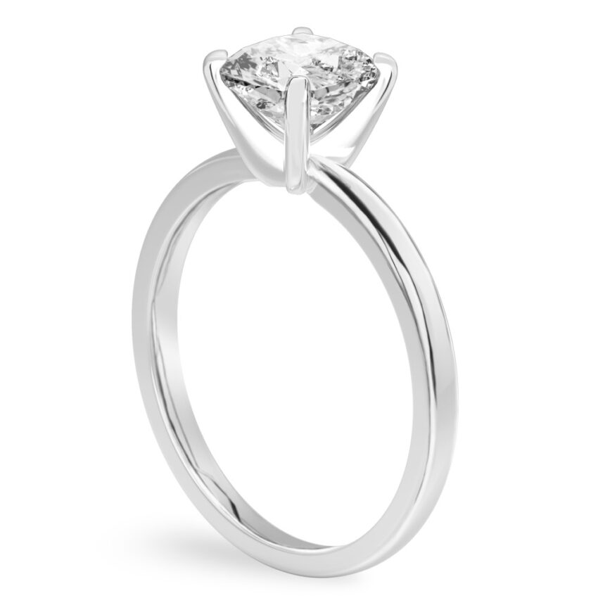 Angle view of cushion cut diamond classic solitaire engagement ring in platinum