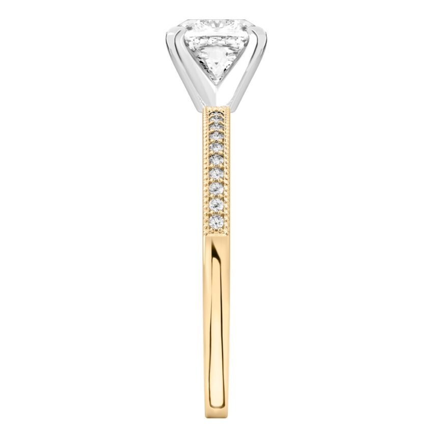 Side view of cushion cut diamond petite milgrain diamond engagement ring in yellow gold