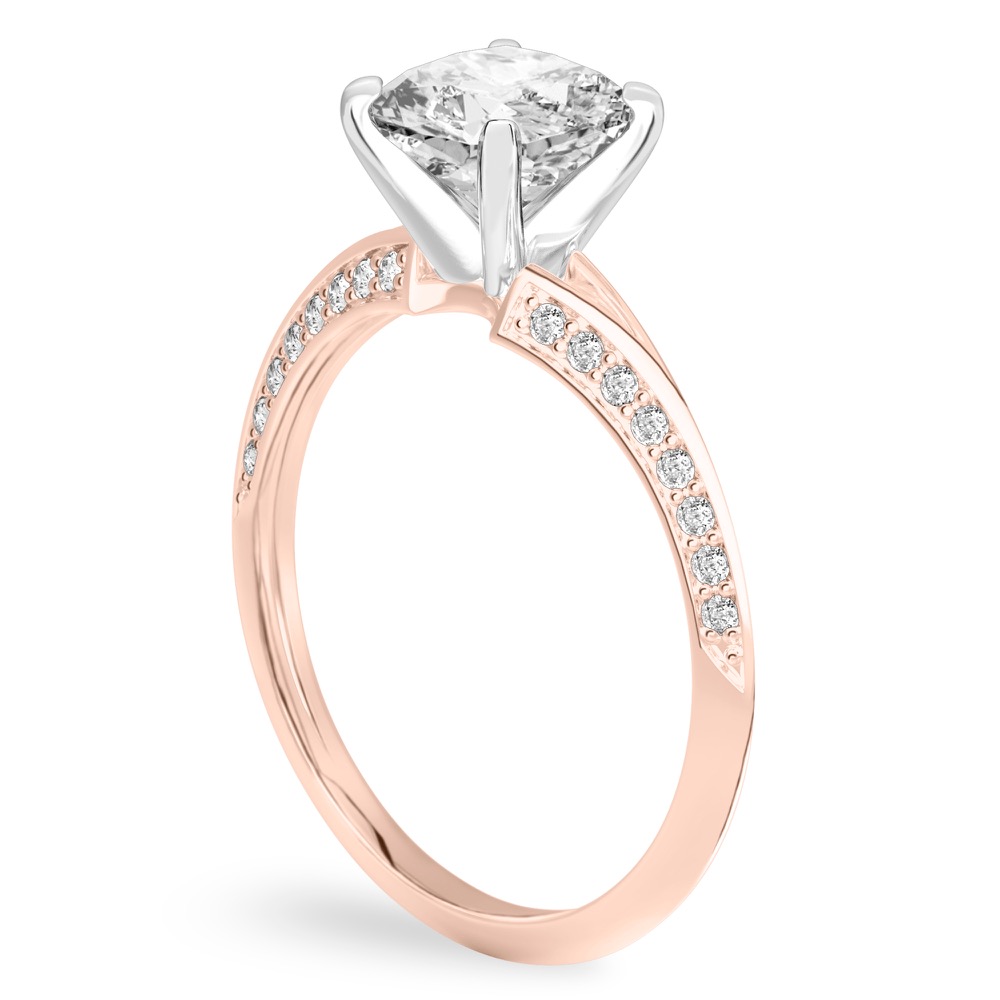 Angle view of cushion cut diamond split shank knife edge engagement ring in rose gold