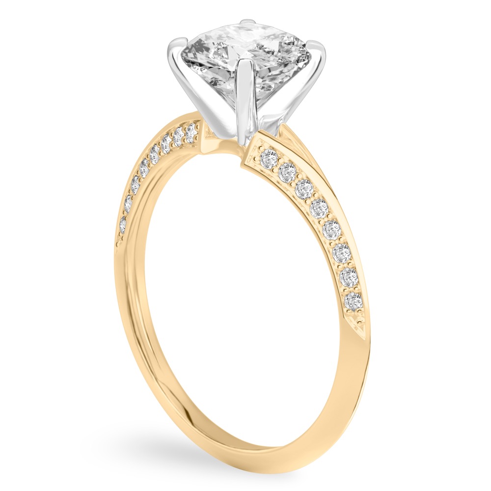 Angle view of cushion cut diamond split shank knife edge engagement ring in yellow gold