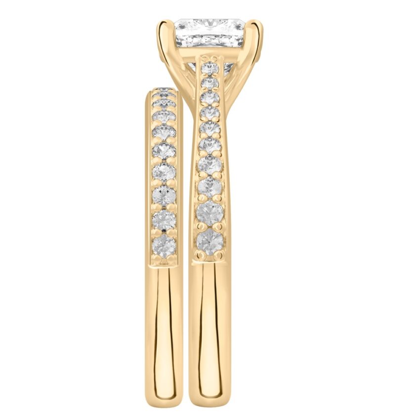 Side view of cushion cut diamond tapered engagement ring set yellow gold