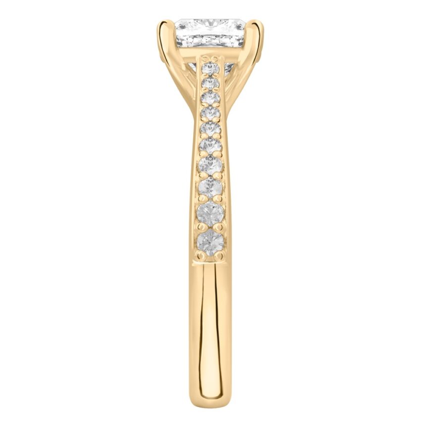 Side view of cushion cut diamond tapered engagement ring in yellow gold