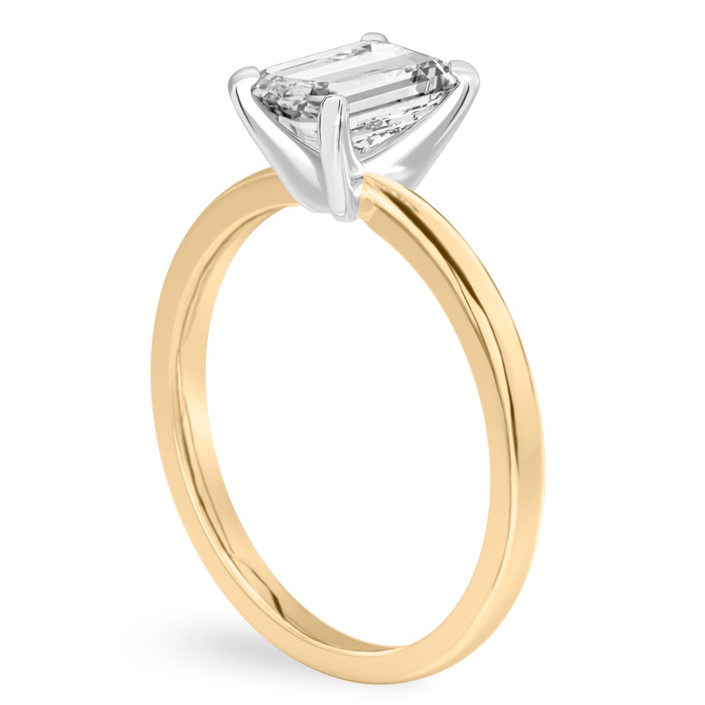 Angle view of emerald cut diamond classic solitaire engagement ring in yellow gold