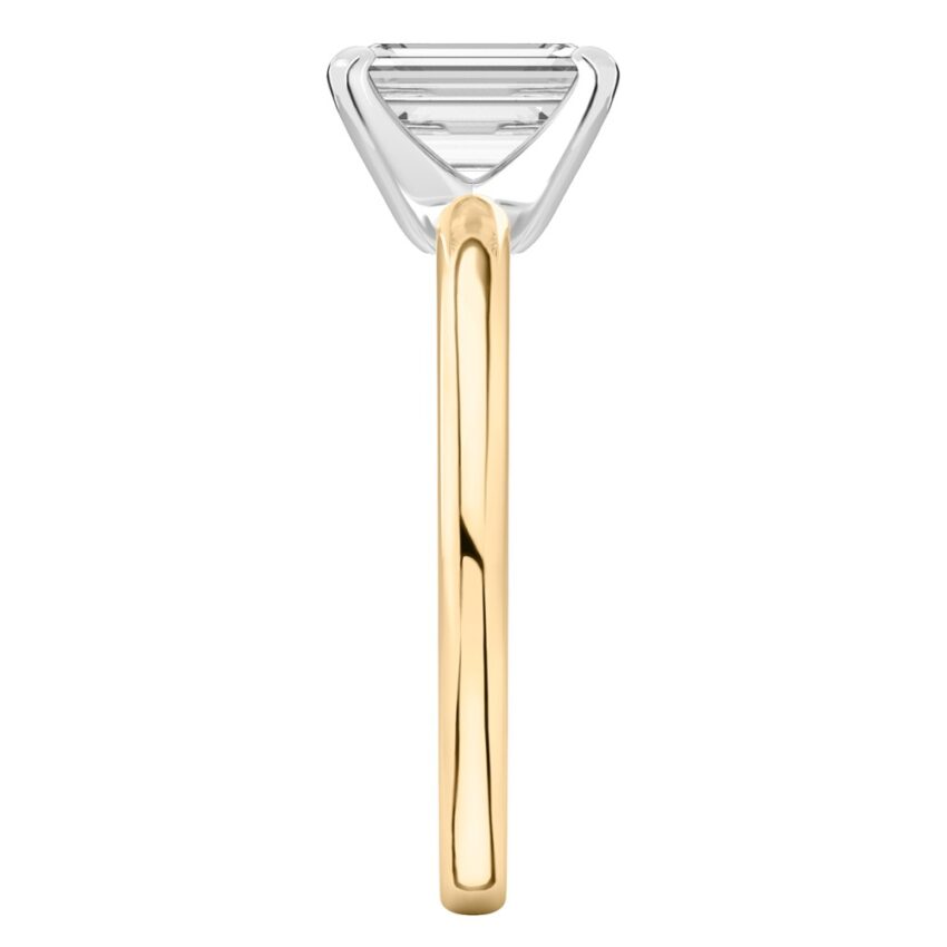 Side view of emerald cut diamond classic solitaire engagement ring in yellow gold