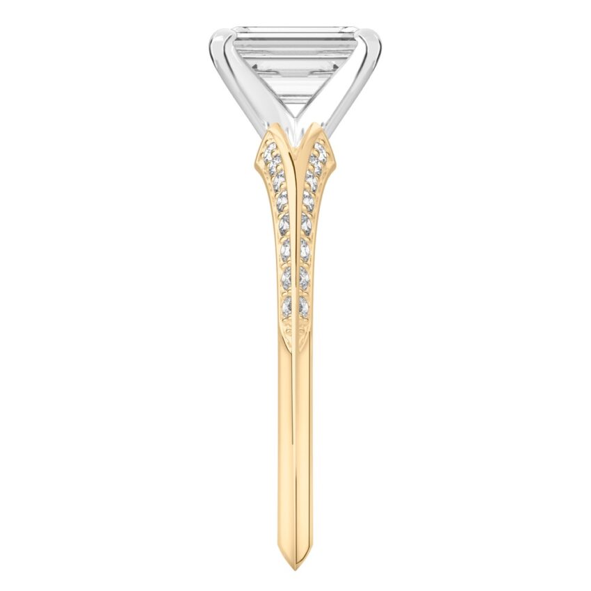 Side view of emerald cut diamond split shank knife edge engagement ring in yellow gold