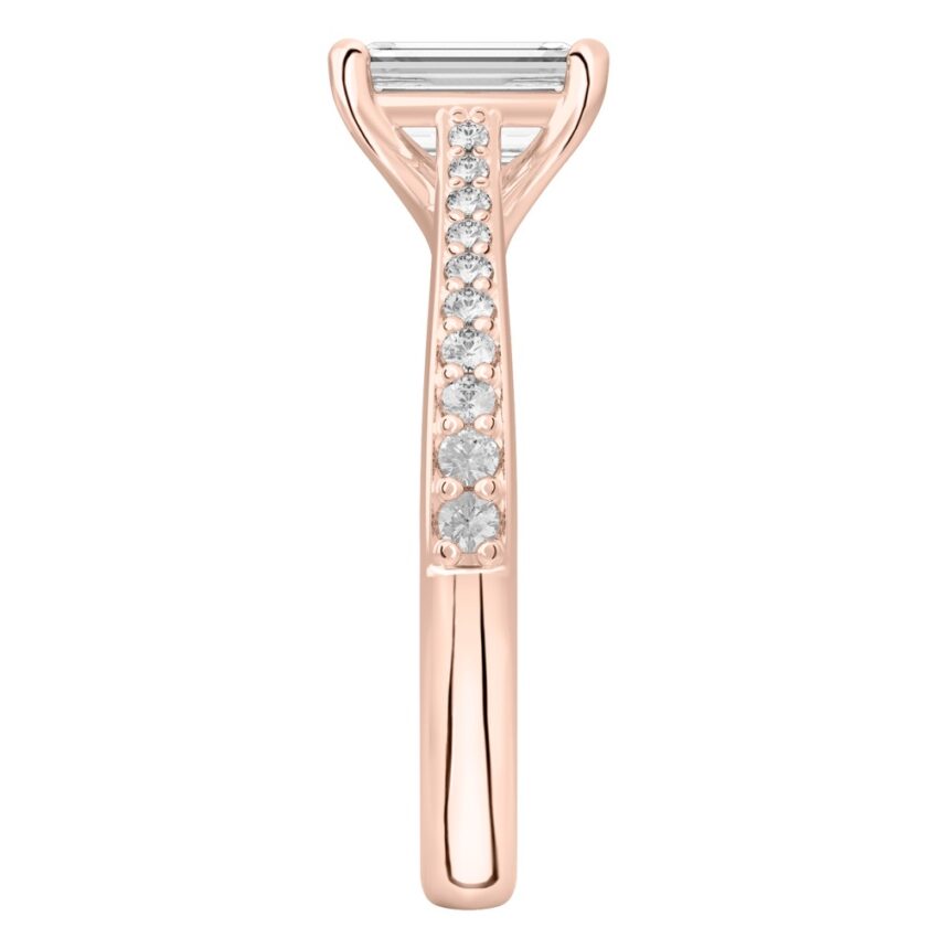 Side view of emerald cut diamond tapered engagement ring in rose gold