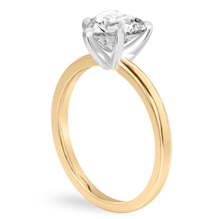 Angle view of heart shape diamond classic solitaire engagement ring in yellow gold