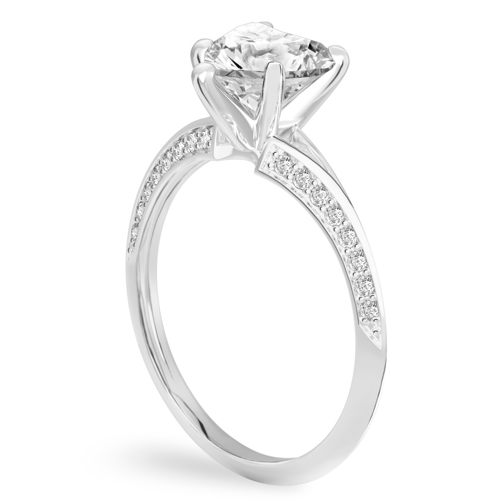 Angle view of heart shape diamond split shank knife edge engagement ring in platinum