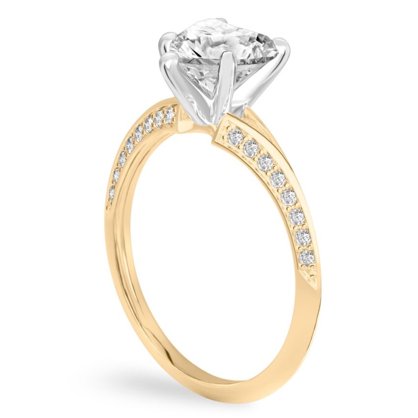 Angle view of heart shape diamond split shank knife edge engagement ring in yellow gold