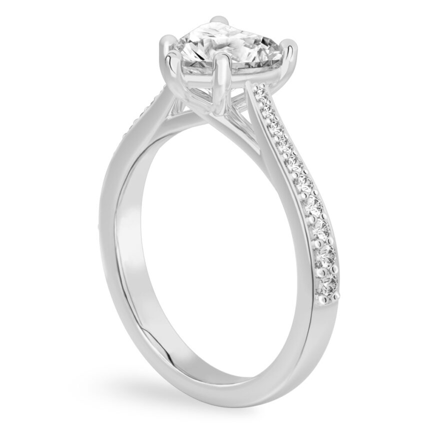 Angle view of heart shape diamond tapered engagement ring in platinum