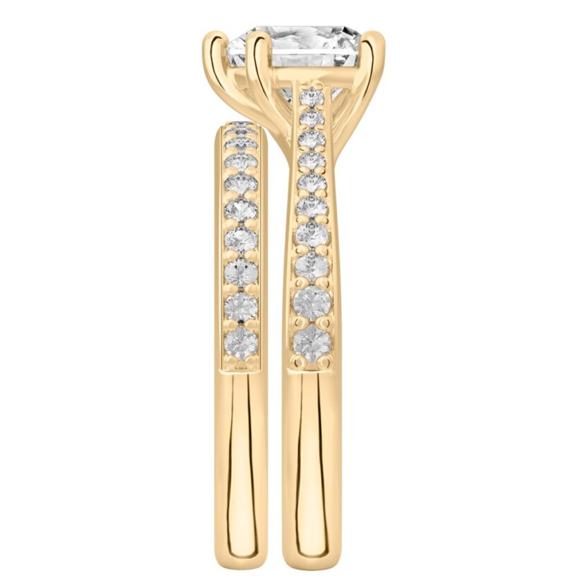 Side view of heart shape diamond tapered engagement ring set yellow gold