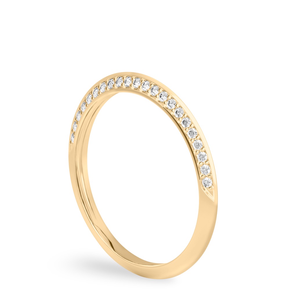 Angle view of knife edge wedding band in with diamonds yellow gold