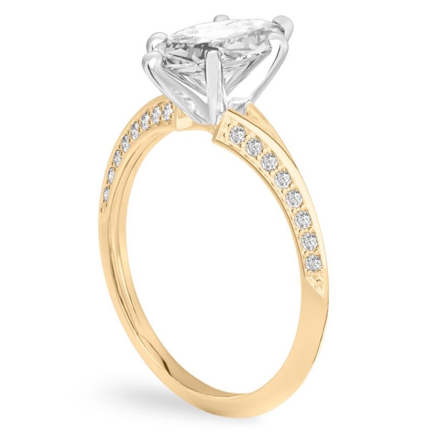 Angle view of marquise cut diamond split shank knife edge engagement ring in yellow gold