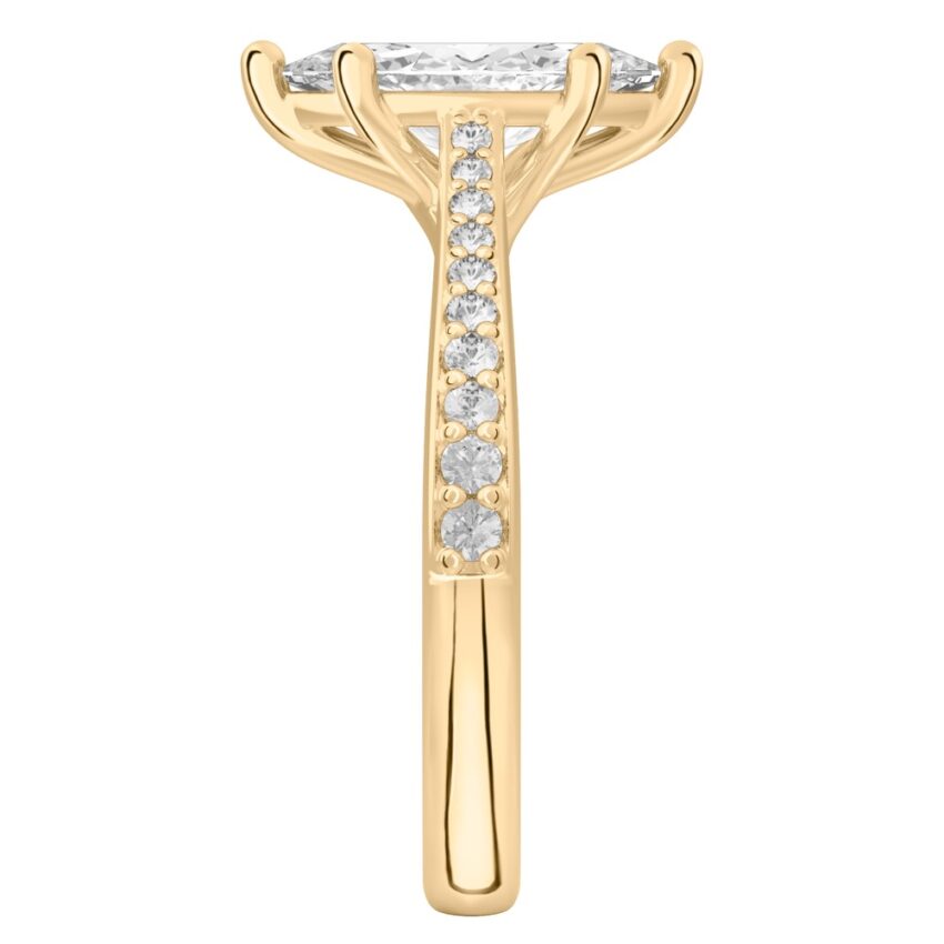 Side view of marquise cut diamond tapered engagement ring in yellow gold