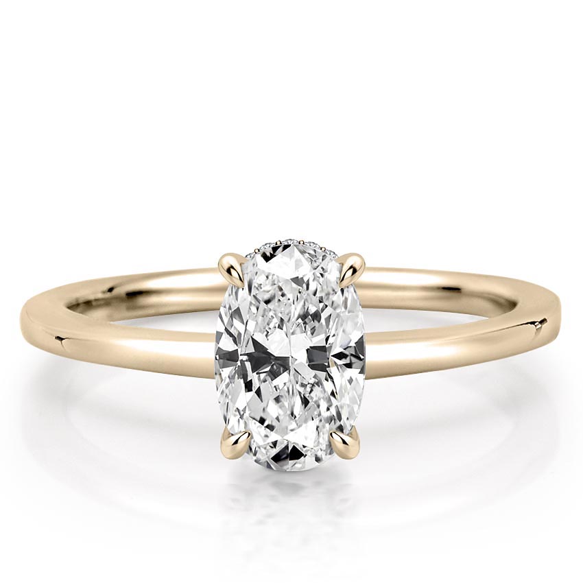 oval shape diamond secret halo engagement ring in yellow gold