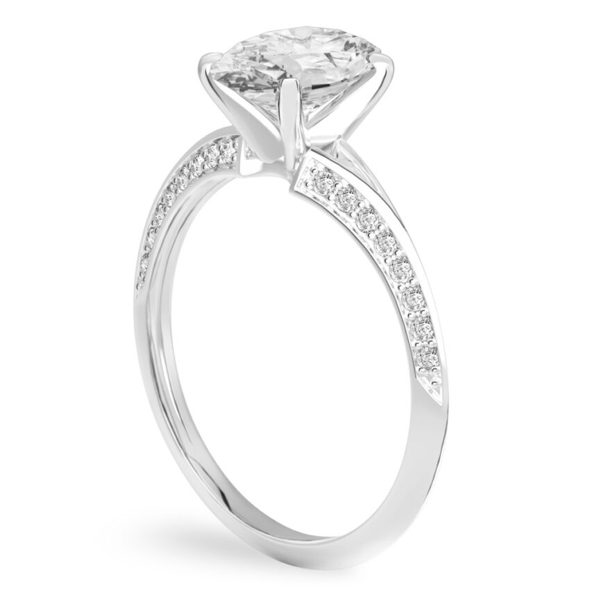 Angle view of oval shape diamond split shank knife edge engagement ring in palladium