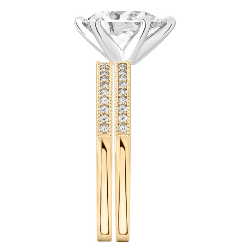 Side view of pear shape diamond petite milgrain diamond engagement ring set yellow gold