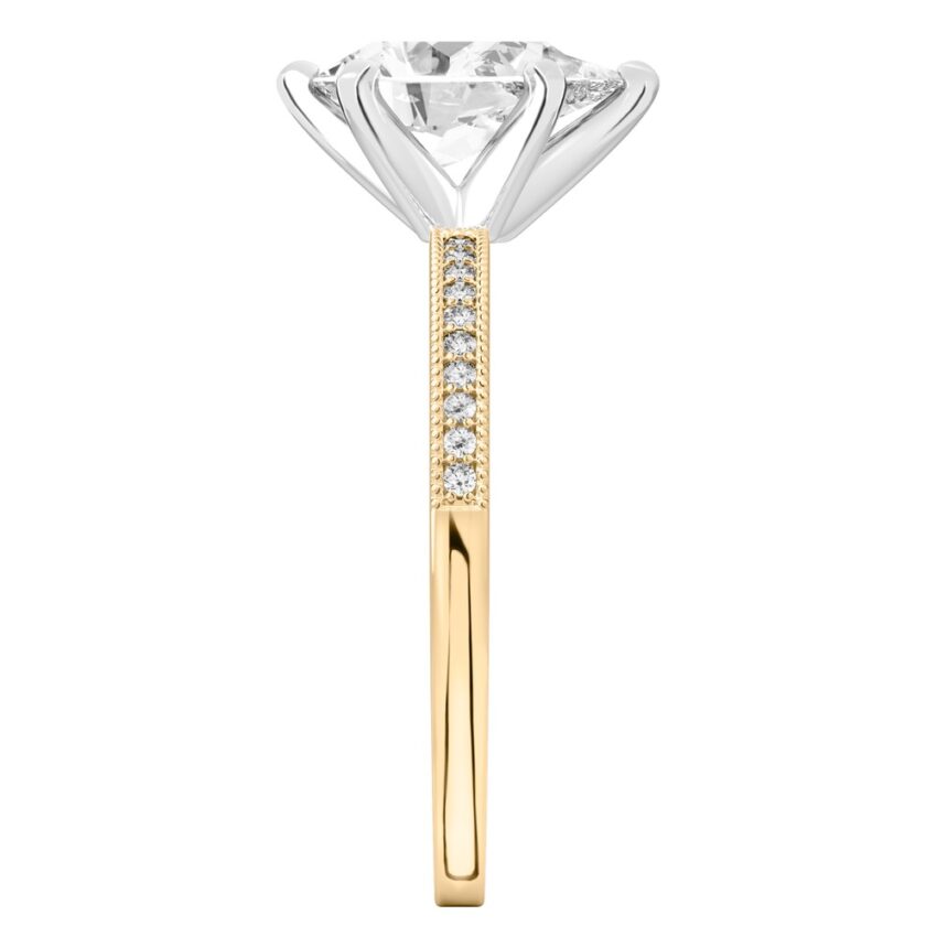 Side view of pear shape diamond petite milgrain diamond engagement ring in yellow gold