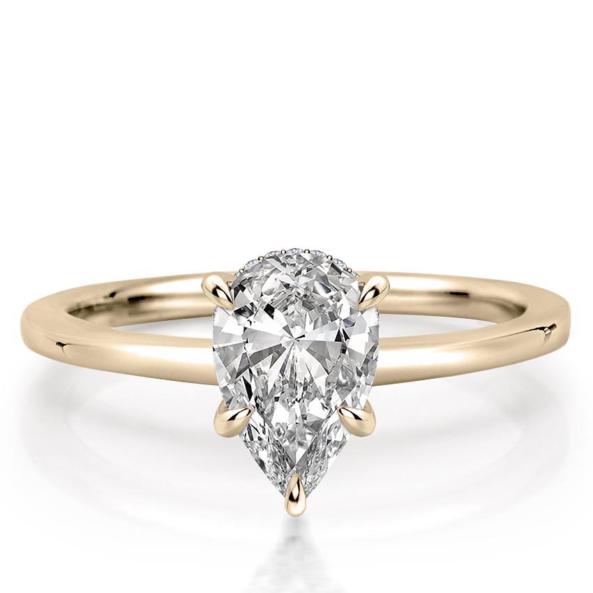 pear shape diamond secret halo engagement ring in yellow gold