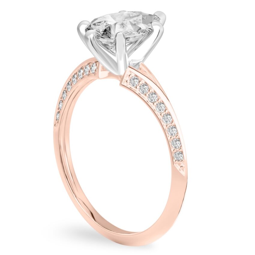 Angle view of pear shape diamond split shank knife edge engagement ring in rose gold