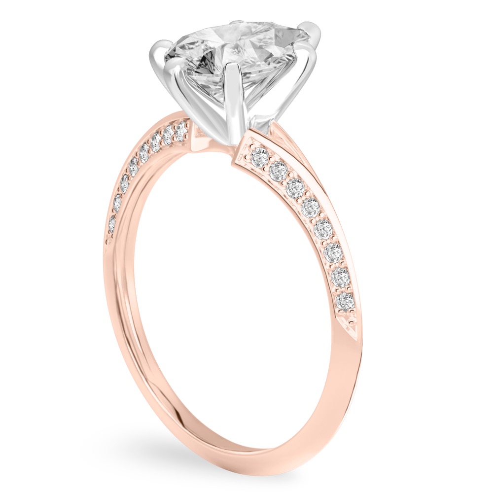 Angle view of pear shape diamond split shank knife edge engagement ring in rose gold